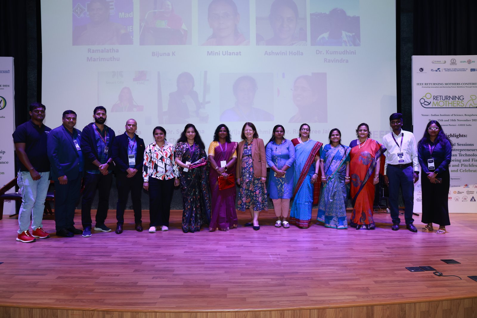 Conference speakers and participants sharing a moment